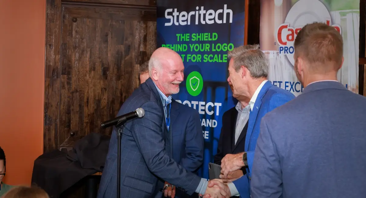 ESFA winner shaking hands with Doug Sutton, Steritech President